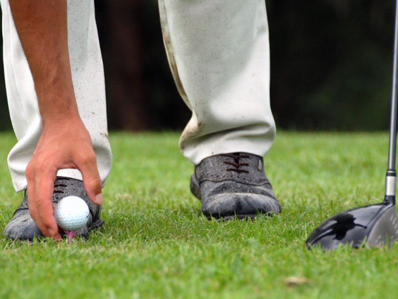 Placing Golf Ball On Tee